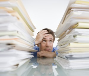 Businessman Overwhelmed with Paperwork